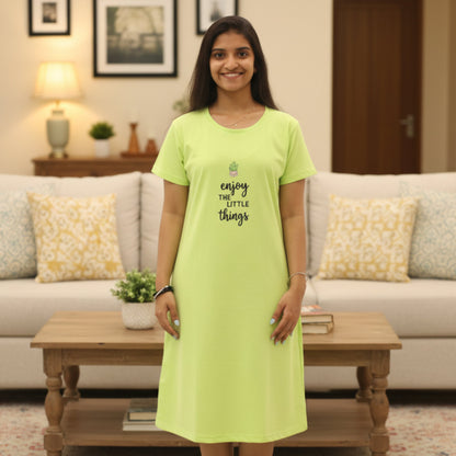 Woman wearing a parrot green cotton short nighty with graphic design in front 