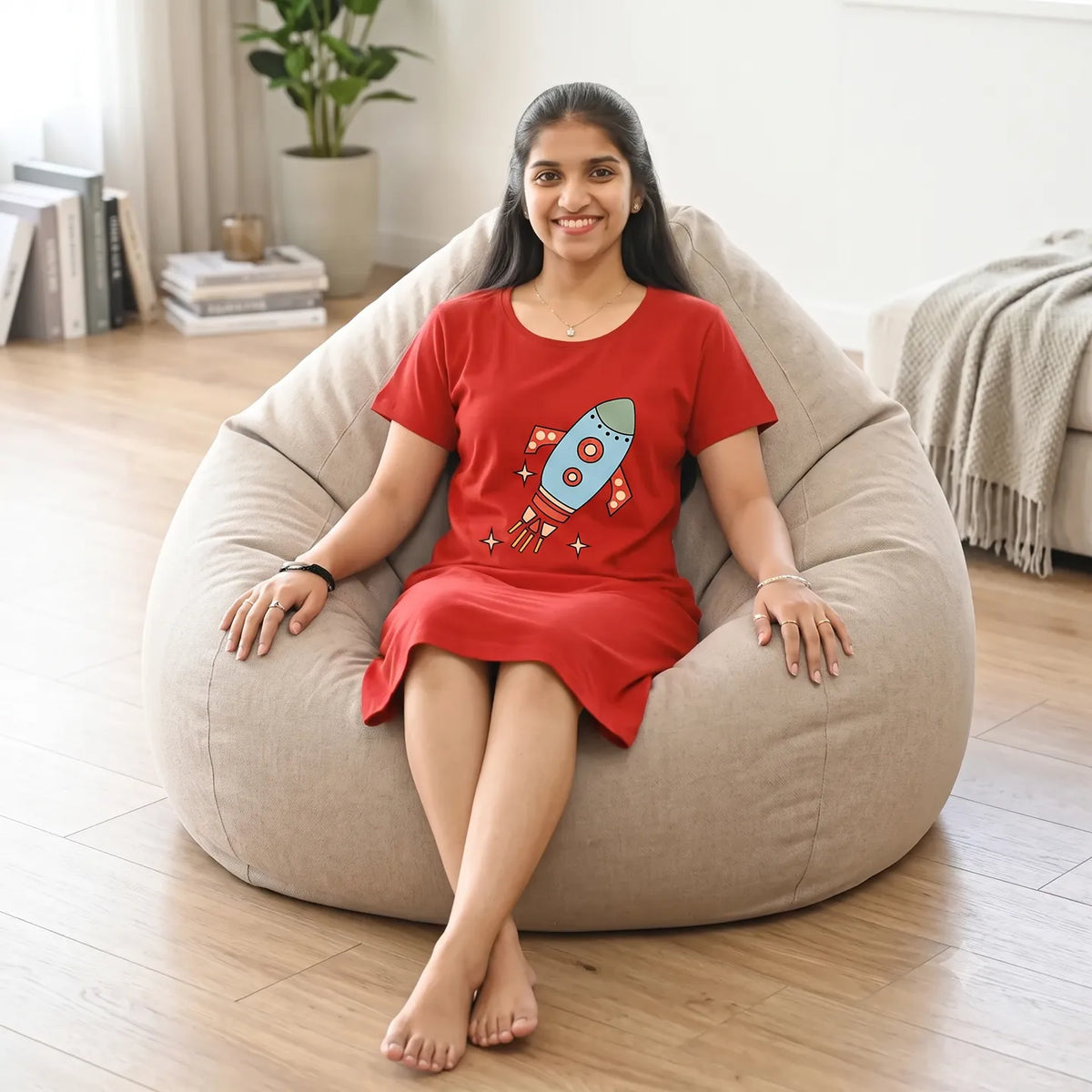 women sitting in a bean bag wearing cotton knee length short nighty