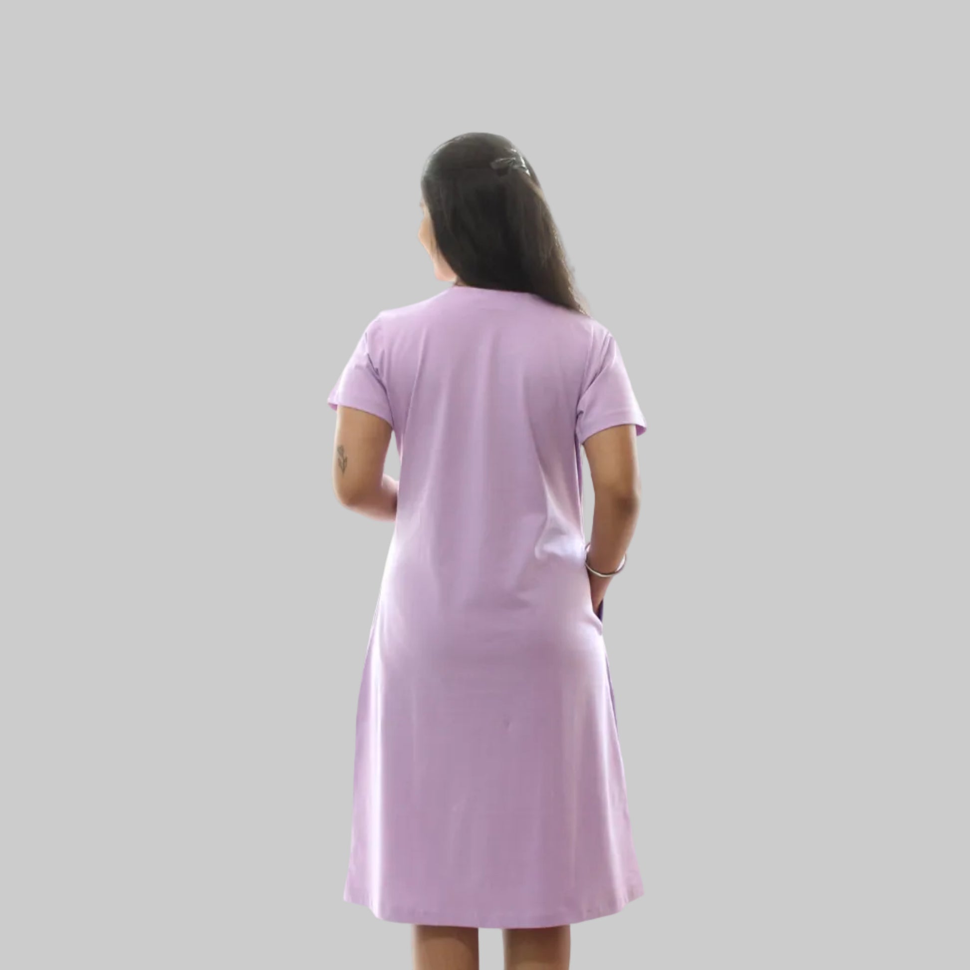women wearing a lavender color cotton short nighty, standing backwards