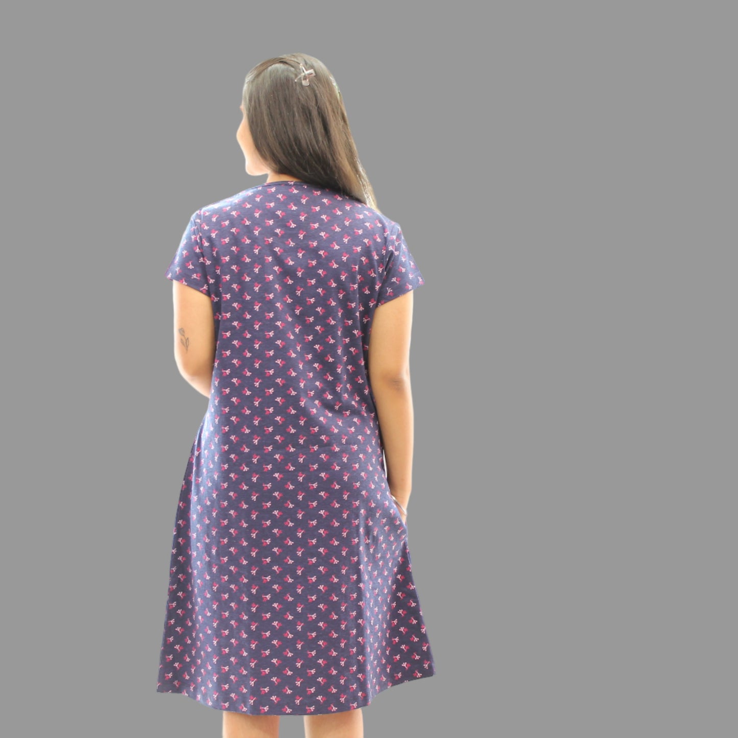women wearing navy blue cotton short nighty with all over print, standing showing the backside view 
