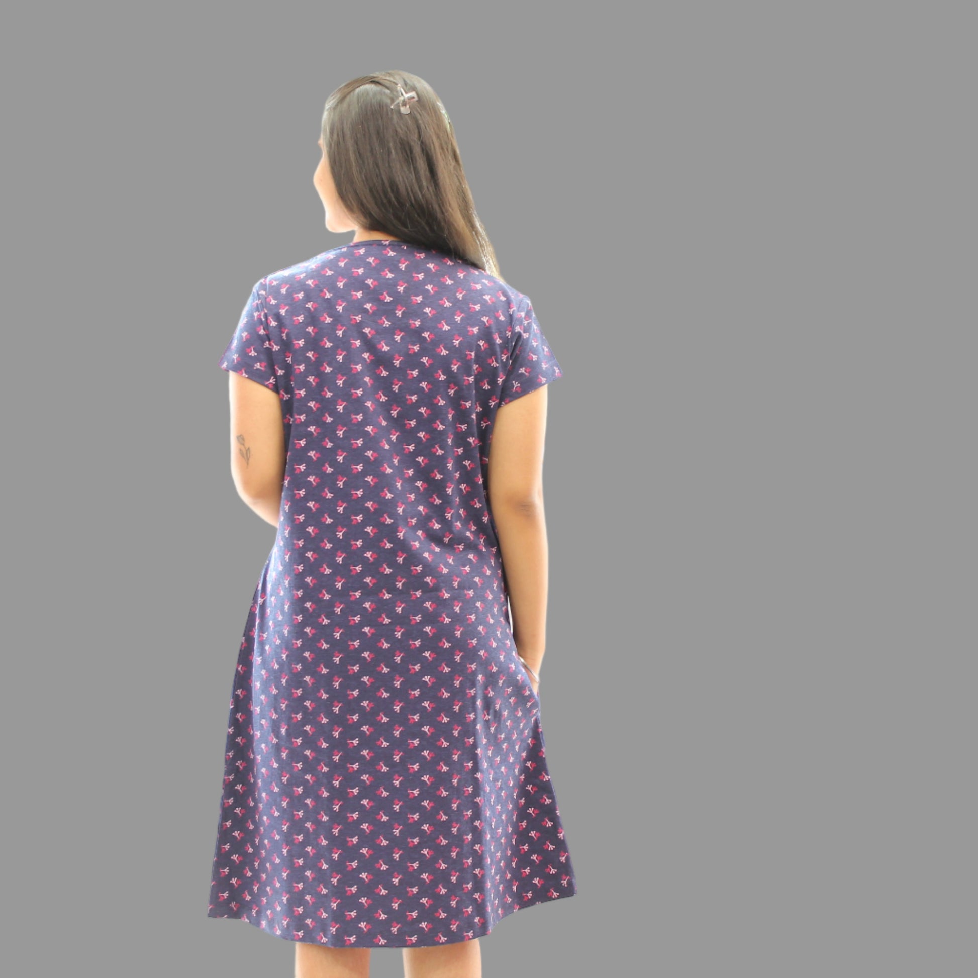 women wearing navy blue cotton short nighty with all over print, standing showing the backside view 