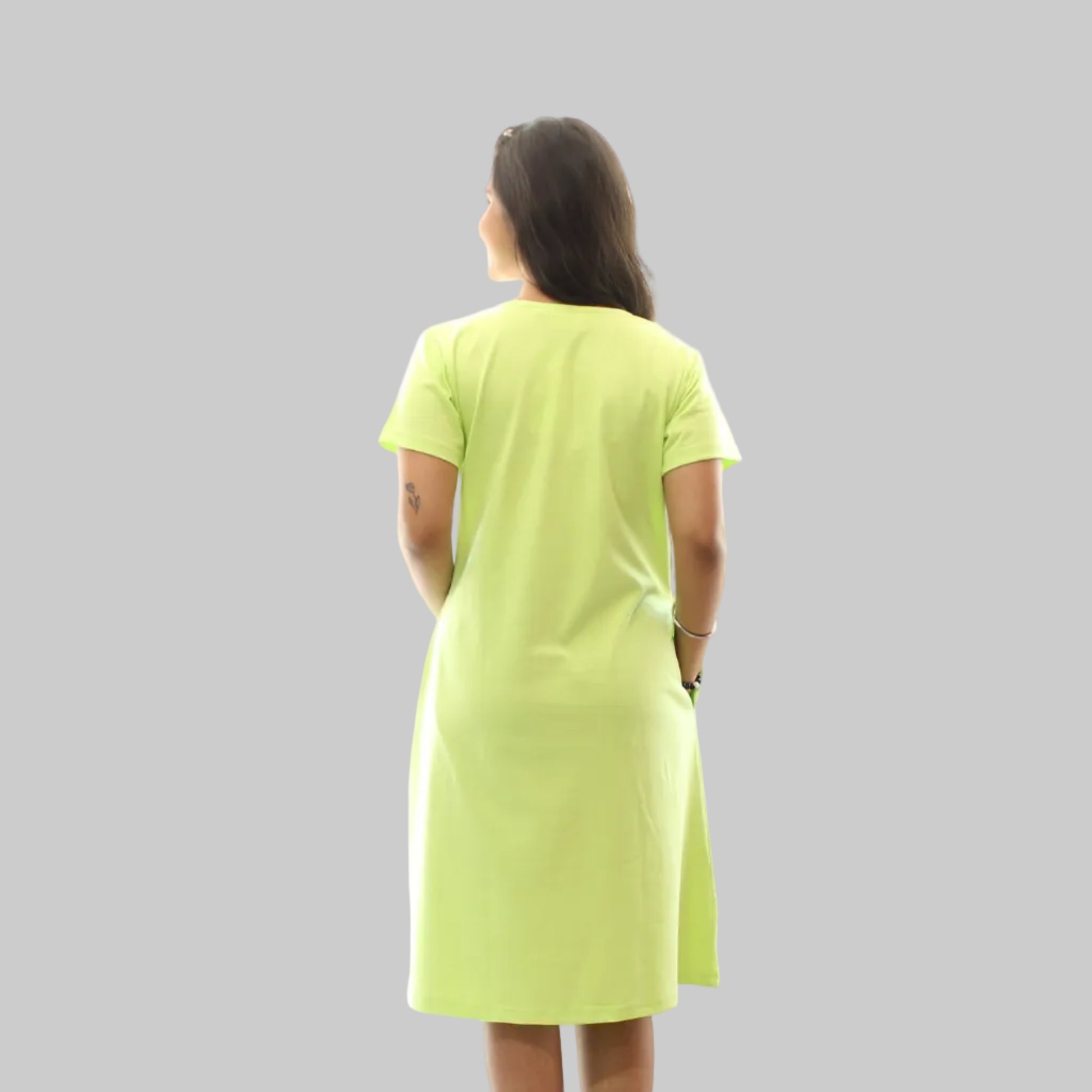 women wearing a parrot green colour short nighty , back view 