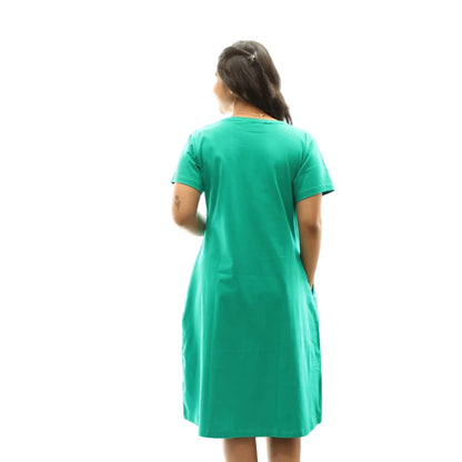 women wearing rama green color standing showing the back view of the dress