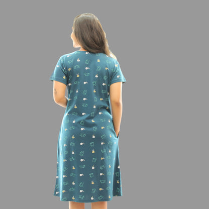 women wearing teal color cotton short nighty with all over printing, standing backwards