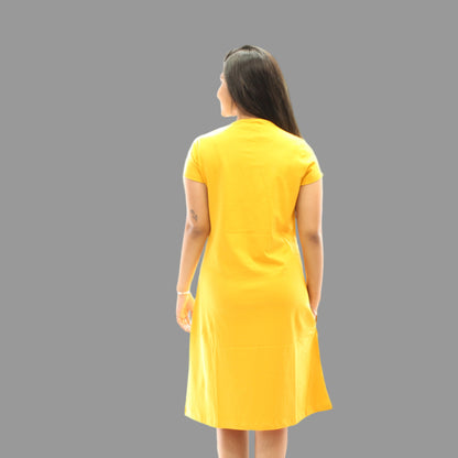 women standing backwards wearing an yellow color short nighty 