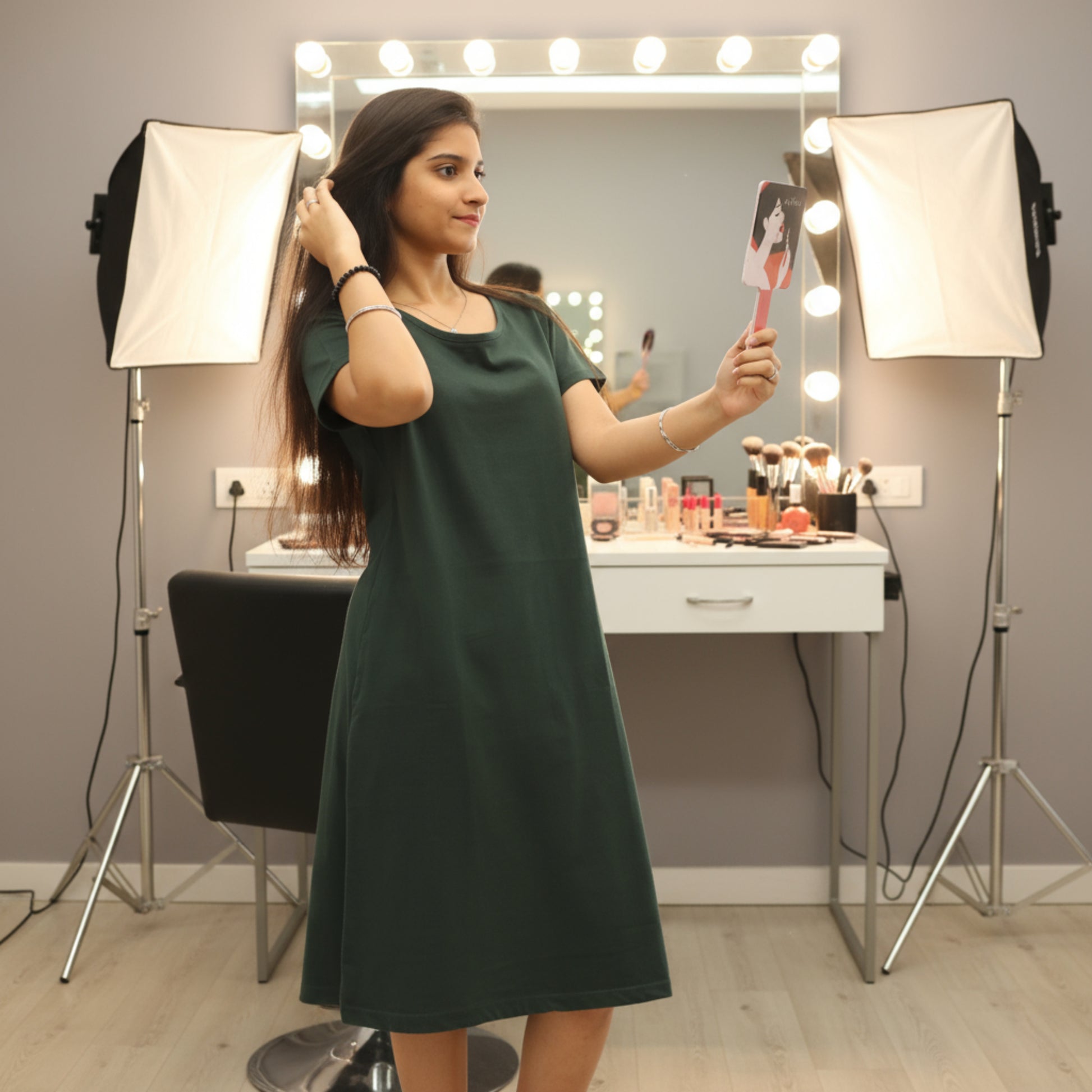 women wearing bottle green color cotton t shirt dress holding a hand mirror