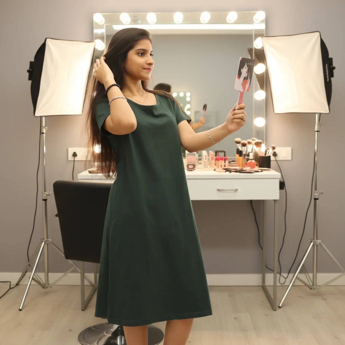 women wearing bottle green color cotton t shirt dress holding a hand mirror 