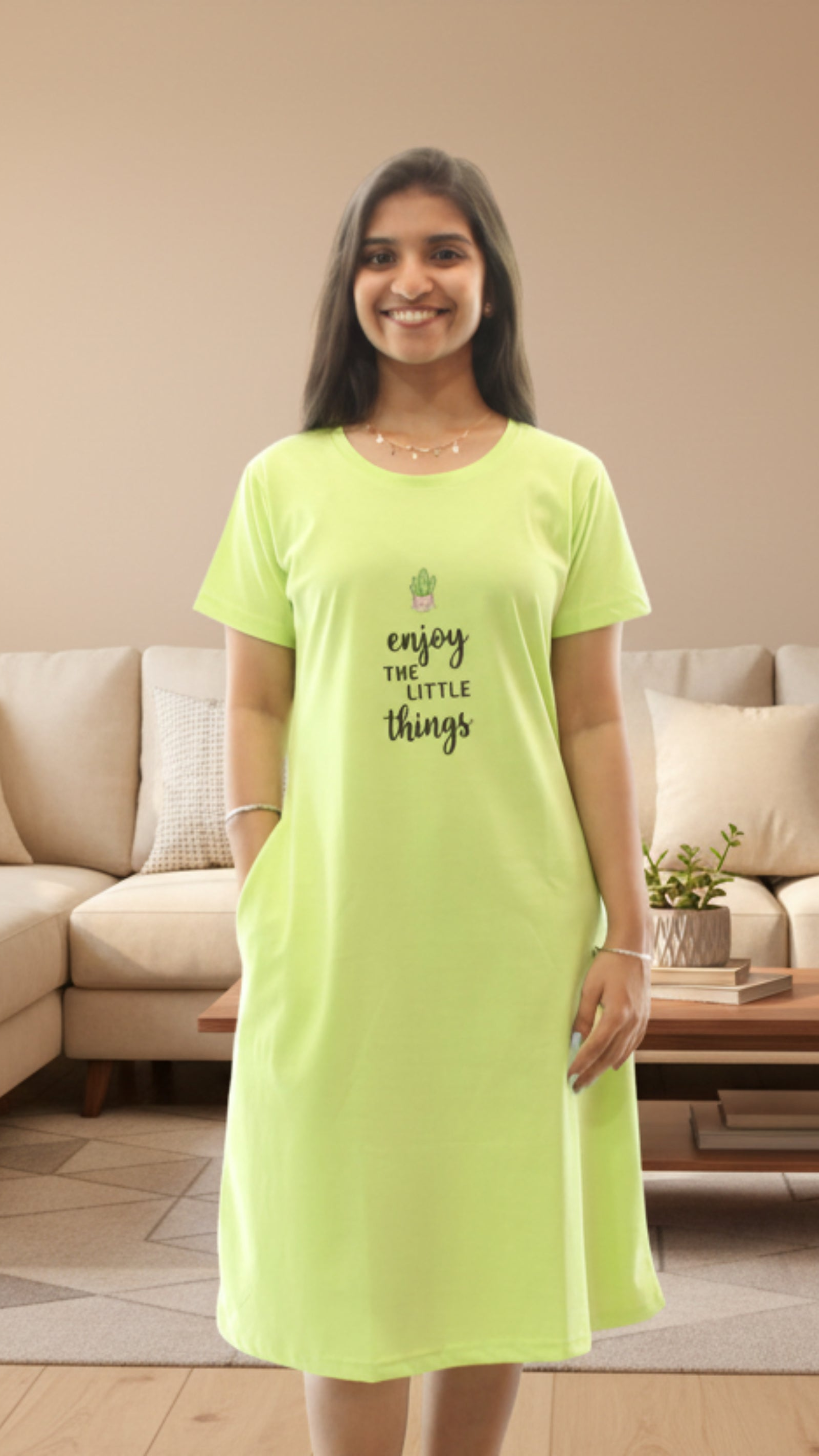 Woman wearing a bright green nightshirt with text in a living room.
