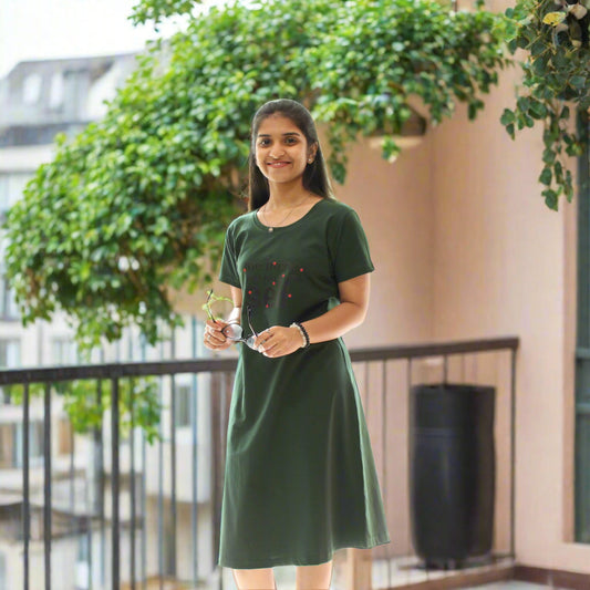 women wearing green color cotton short nighty, holding a goggles in hand