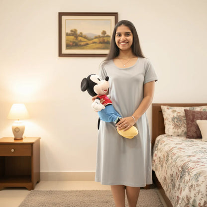 women wearing light grey t shirt dress , holding a mickey mouse doll