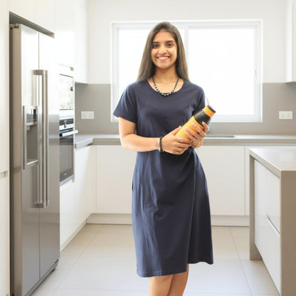 women holding a water bottle, wearing navy blue cotton t shirt dress