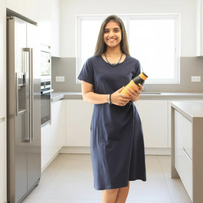women holding a water bottle, wearing navy blue cotton t shirt dress