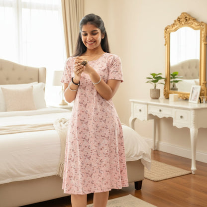 women wearing light pink short nighty with prints all over. 
