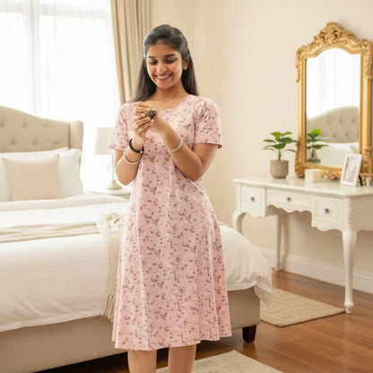 women wearing light pink short nighty with prints all over. 