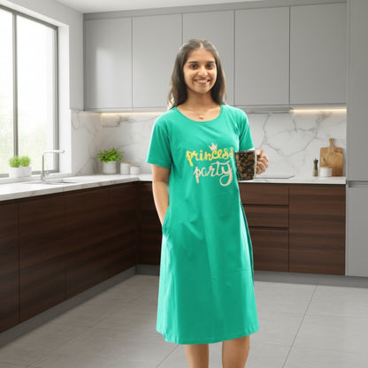 women wearing rama green color cotton short nighty with print in chest area, holding a coffe mug