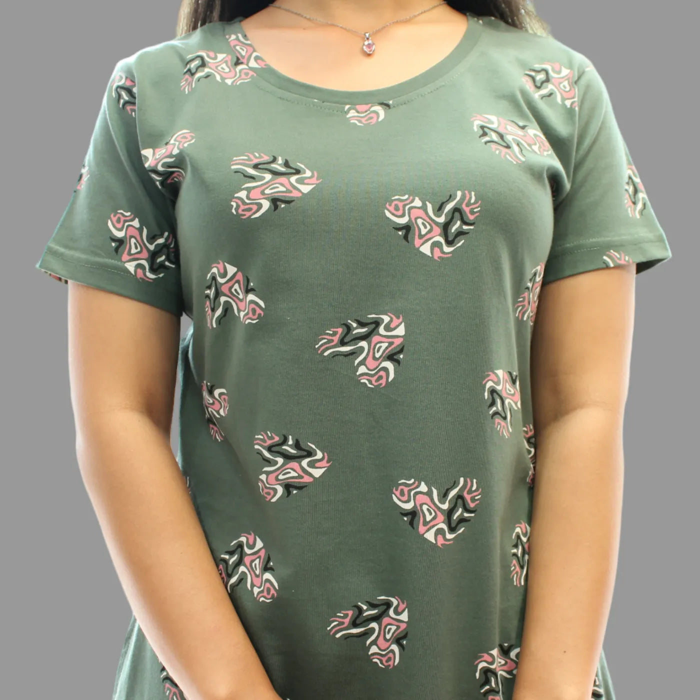 close up view of fabric of women wearing cotton light green color short nighty with all over prints