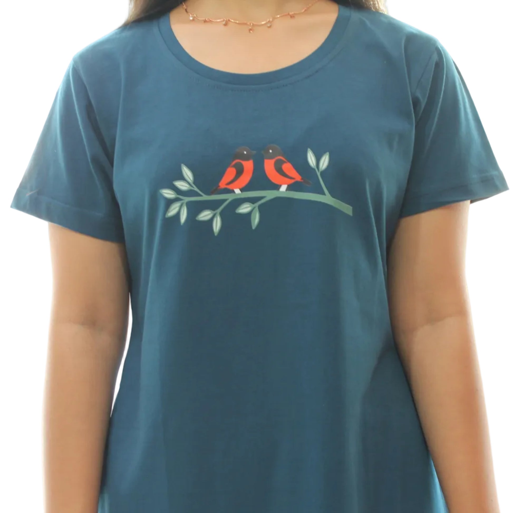 women wearing a teal short nighty with a graphic design of two birds on a branch.