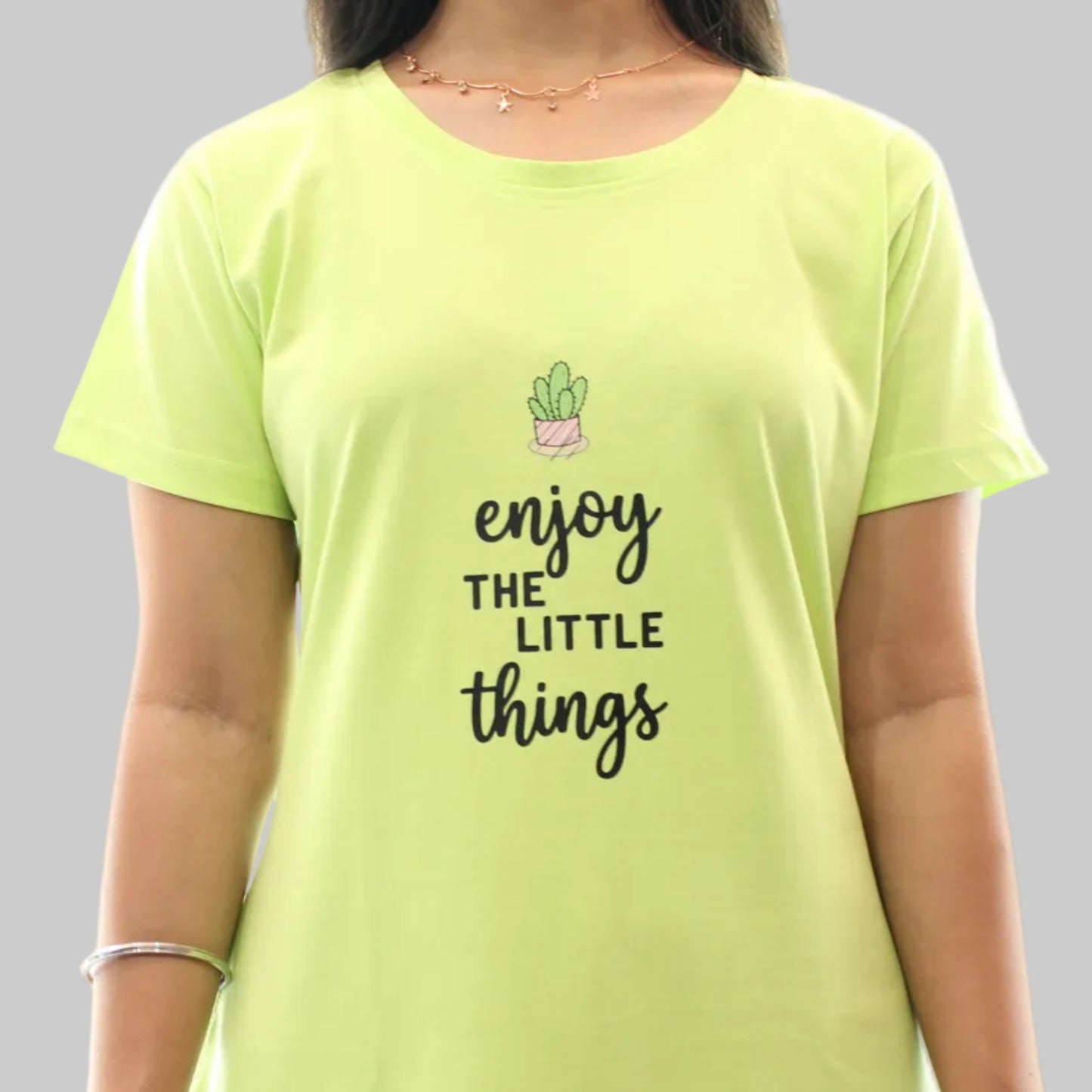 women wearing a parrot green short nighty , close up view of print in the chest area 