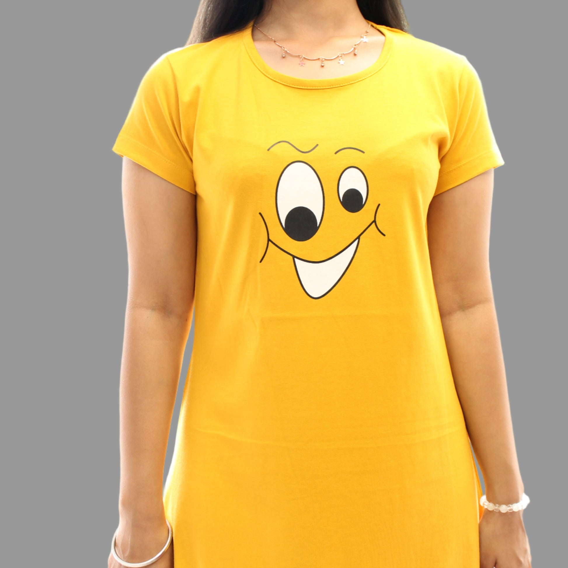 women wearing yellow color cotton short nighty with graphic design in black and white color in chest area