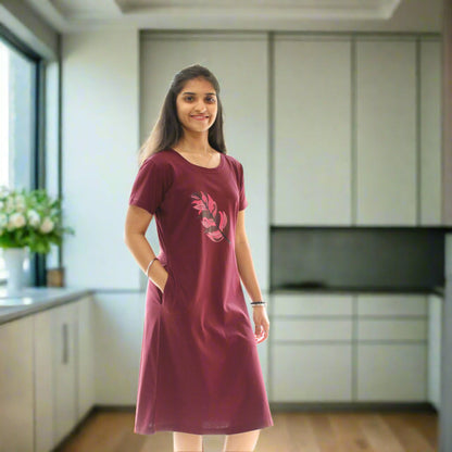 women wearing wine color knee length short nighty with leaf design in the chest area, putting hands in pocket.