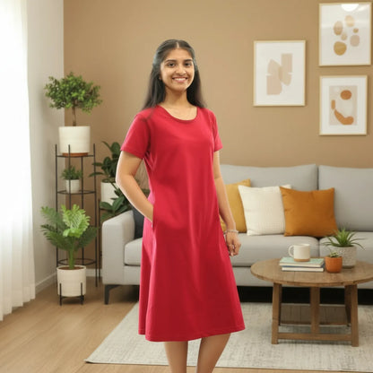 women wearing reddish maroon knee length t shirt dress with hands in pocket