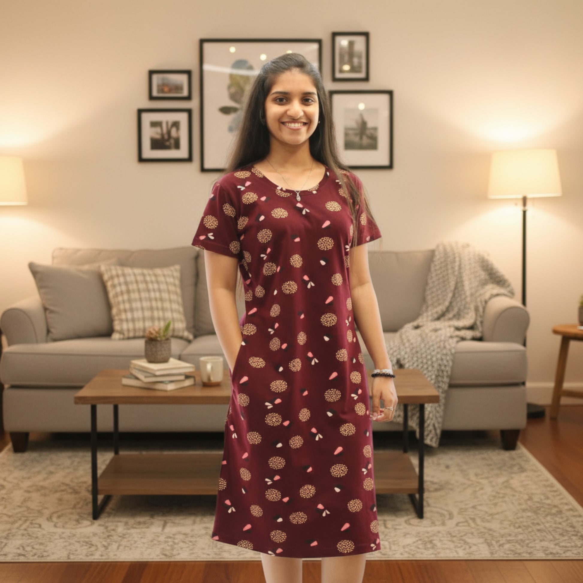 women wearing dark maroon cotton knee length short nighty with all over print design, it has a pocket