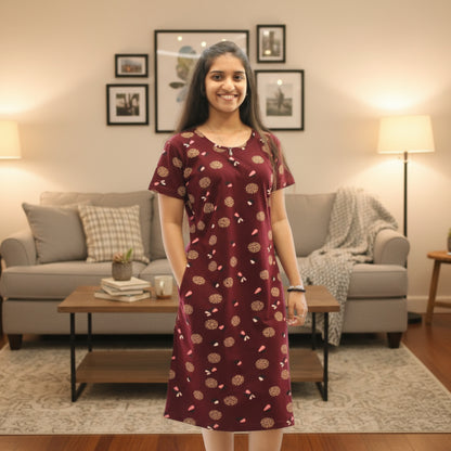 women wearing dark maroon cotton knee length short nighty with all over print design, it has a pocket