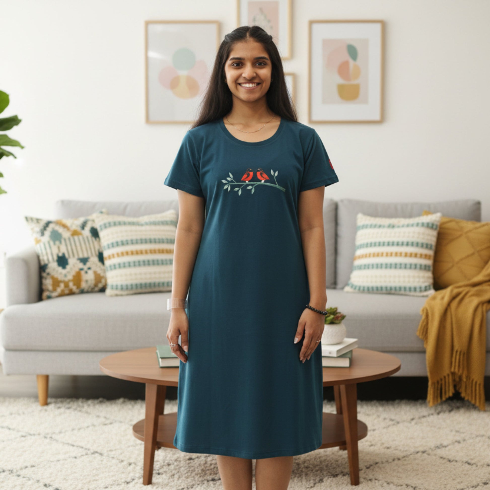 women wearing teal blue color cotton short nighty with pockets, birds in a branch design printed on chest area