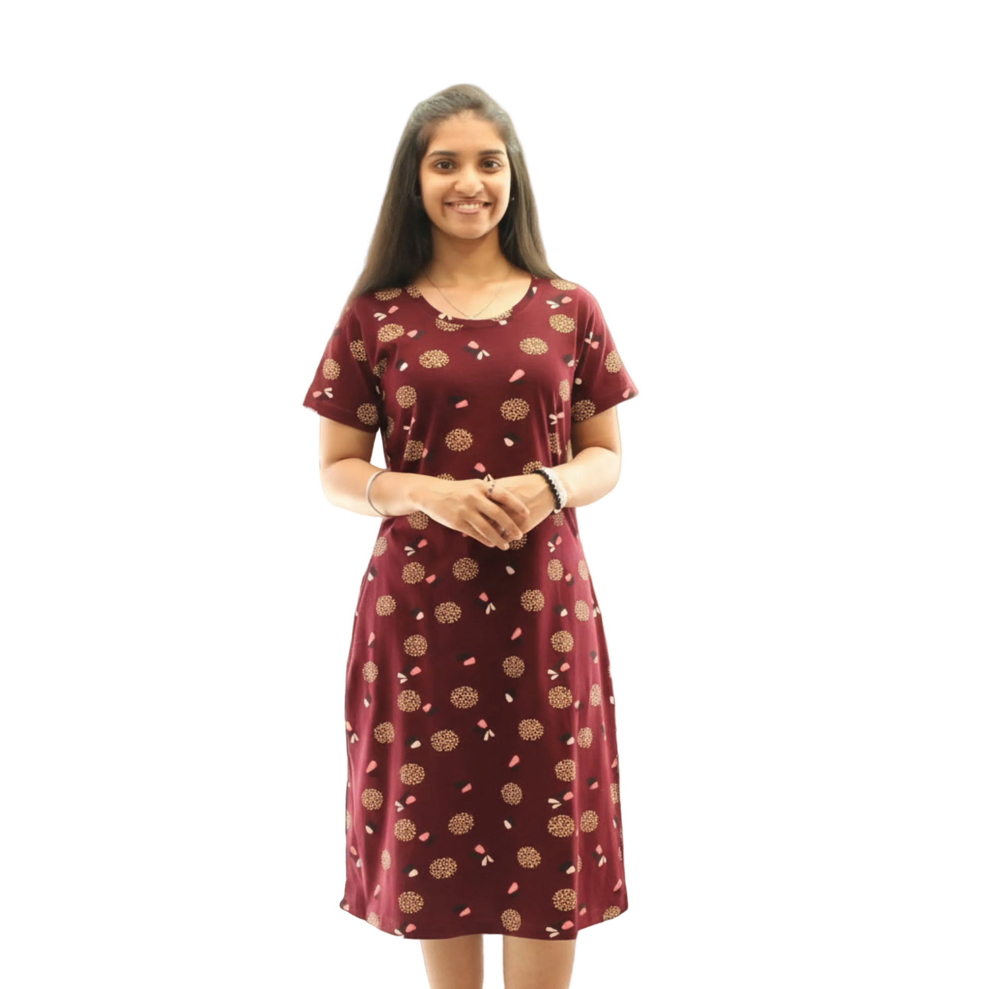 Woman wearing a maroon dress with a pattern on a white background