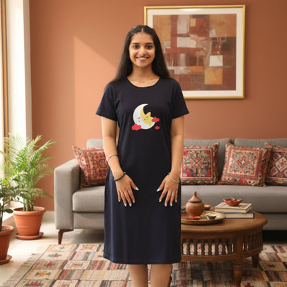 Woman wearing a dark navy cotton short nighty  with a moon design in a living room.
