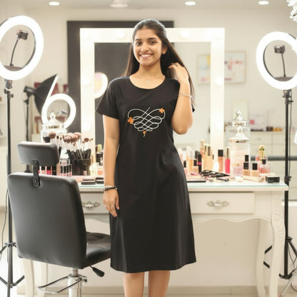 women wearing black short gown , floral print in the chest area
