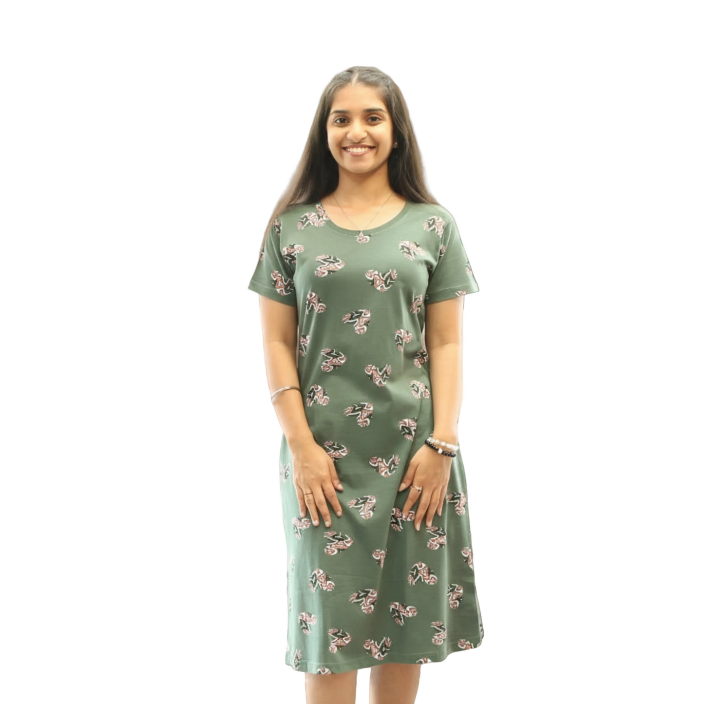 Woman wearing a green dress with a floral pattern on a white background