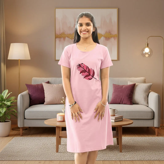 women wearing a light pink color cotton knee length short nighty and standing in a living room