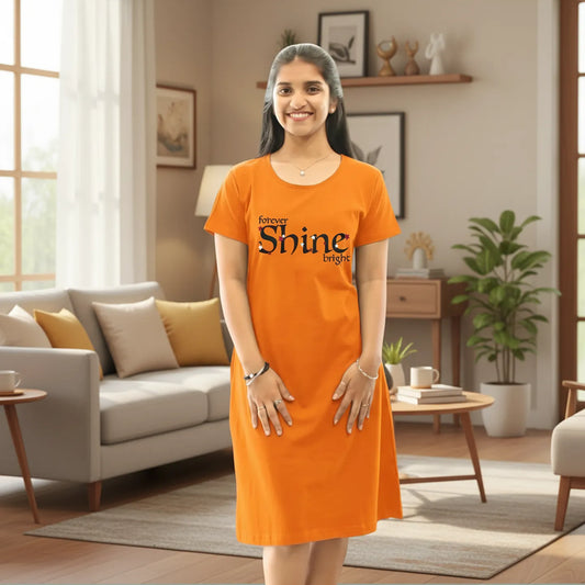 women wearing a orange color cotton knee length short nighty with text forever shine bright printed in chest area 