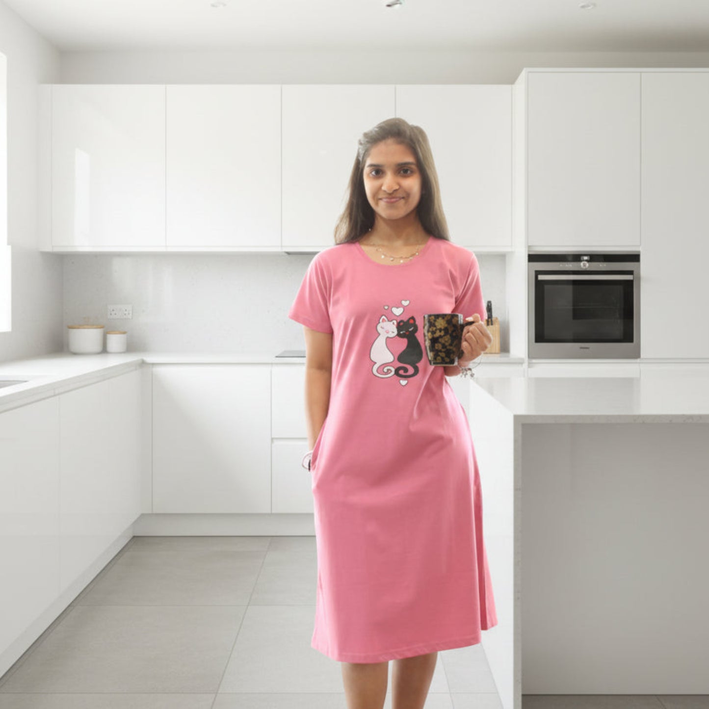 women wearing pink short nighty with pocket, holding a mug