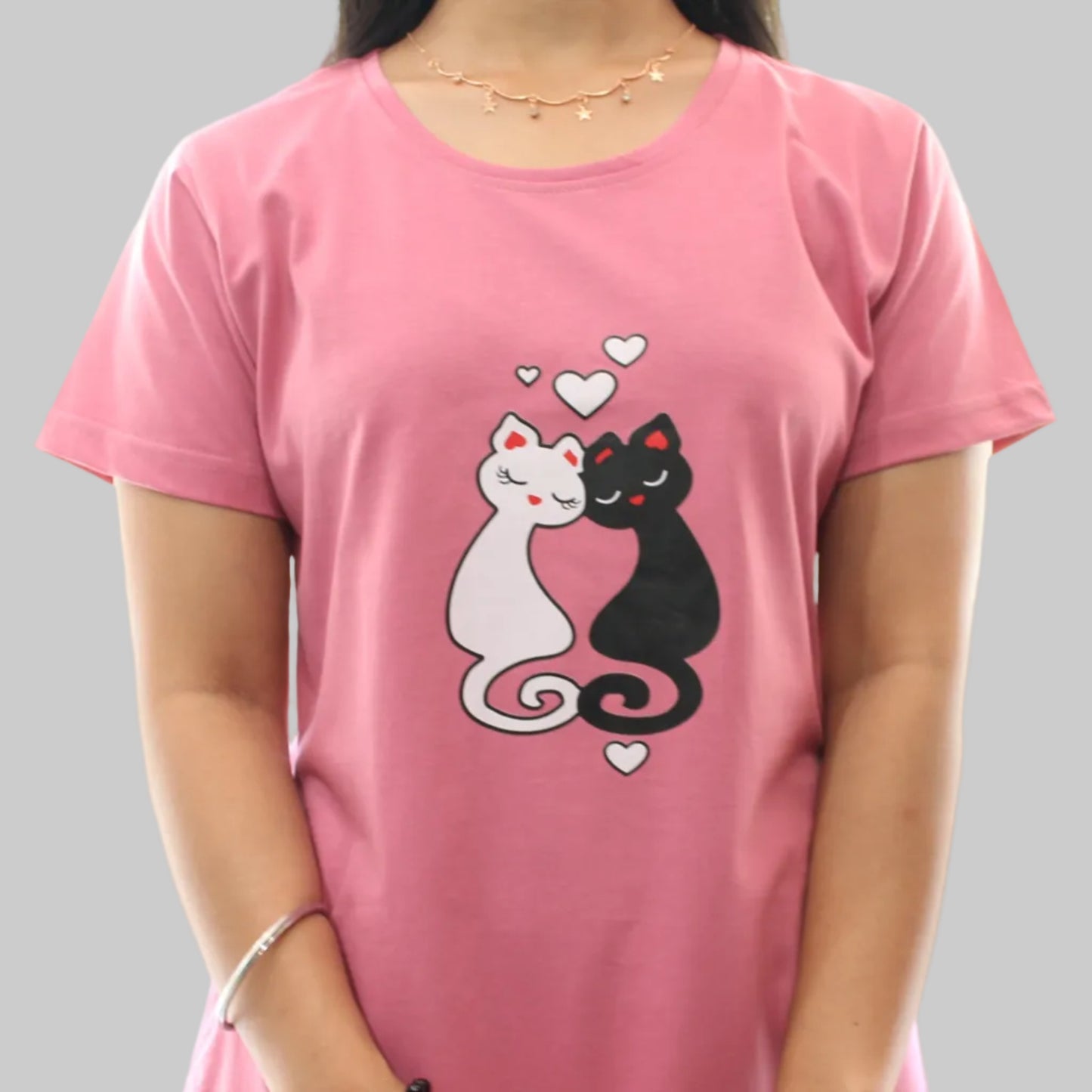 women wearing a pink short nighty  with cat design on a white background