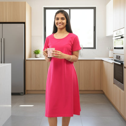 women wearing pink color cotton knee lengt t shirt dress holding a mug